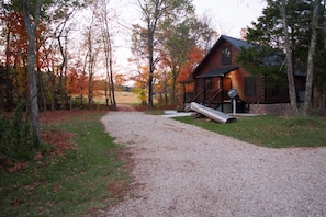 Looking up the driveway toward the road, fall foliage and open fields surround