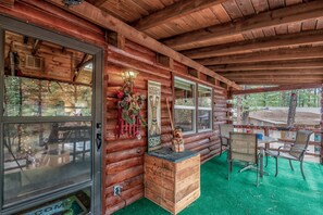 The elevated front porch extends across the front of the cabin with plenty of seating and bistro lights. Perfect for watching wildlife stroll by!