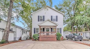 Front of house, front porch, parking for 3 vehicles, plus a golf cart