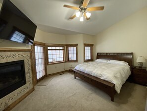 Master bedroom with new King size bed and 65” inch Sony Tv. Deck w/slope view.