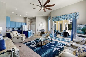 large family room, kitchen, dining nook and TV area with doors to lanai