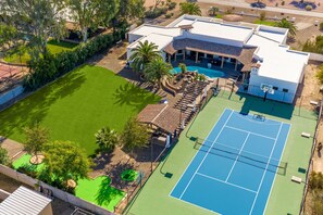 A picturesque masterpiece surrounded by lush greenery, featuring exquisite architecture, glistening pools, and vibrant gardens. The blend of colors and inviting outdoor spaces promises a serene and luxurious