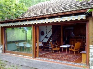 To the south, there are two big panoramic sliding windows/doors, one of which opens up to the terrace.