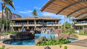 Secluded Luana Enclave pool area with a waterfall and hot tub