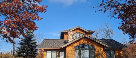 view of cabin and deck from lake