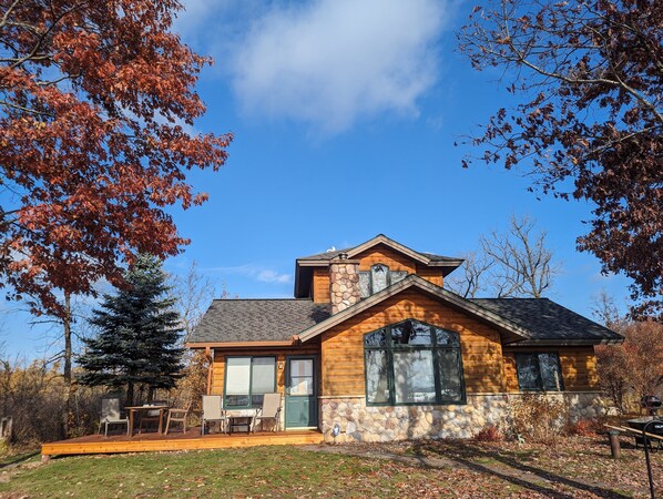 view of cabin and deck from lake