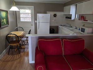 View from the front door looking in. Living area, kitchen.