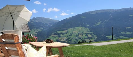 Sky, Mountain, Property, Plant, Green, Cloud, Building, Outdoor Furniture, Wood, Shade