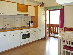 Room, Furniture, Cabinetry, Kitchen, Countertop, Property, Interior Design, Building, Floor, Yellow