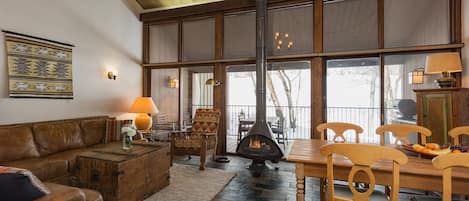 Living Room and Dining Area with Large Windows and Fireplace