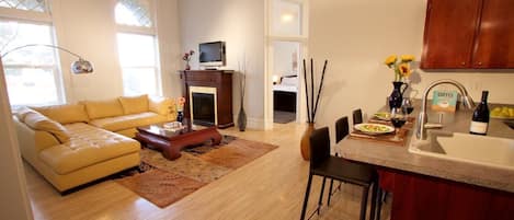 Spacious living room with fireplace overlooks Main Street.