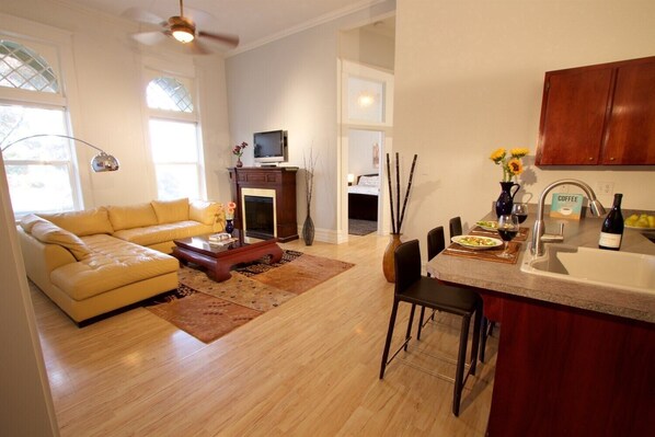 Spacious living room with fireplace overlooks Main Street.