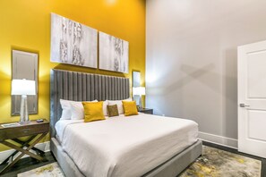 Spacious guest bedroom with a king bed and designer built-in closet. Includes nightstands, lamps, hangers, luggage rack, alarm clock, white noise machine, and a 50'' Samsung Smart 4K TV with streaming and DIRECTV Entertainment.