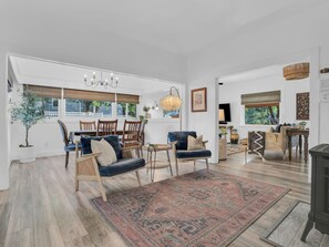 The family room is open to an informal reading area and dining area.