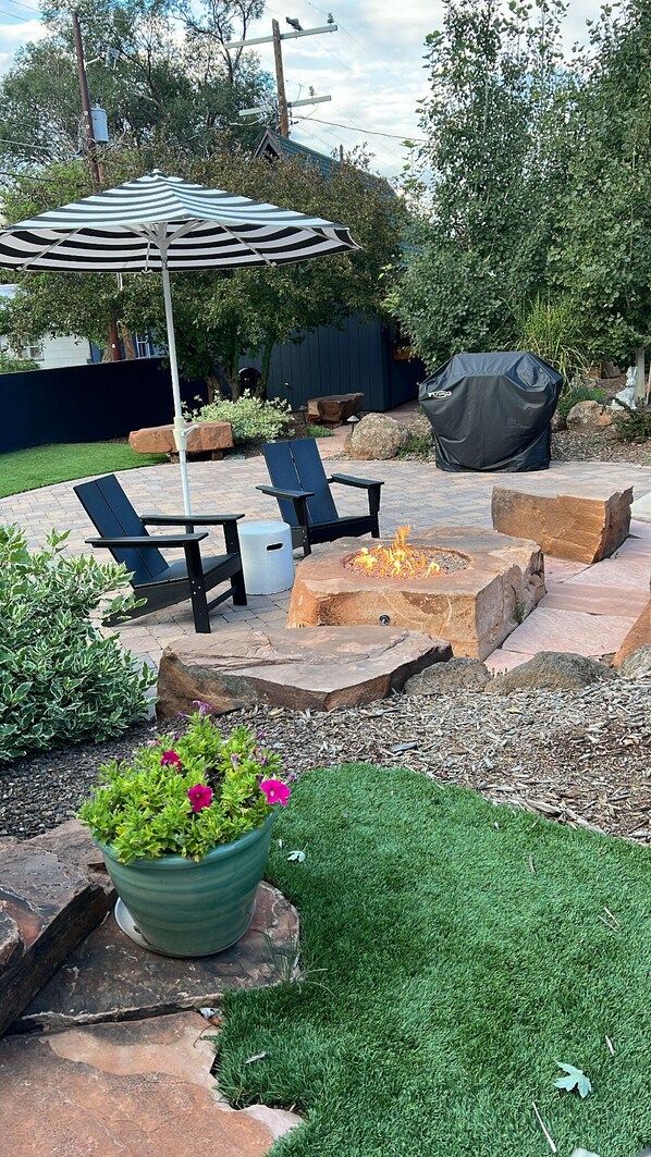 The backyard when fire pit and cornhole court is perfect for friends and family.