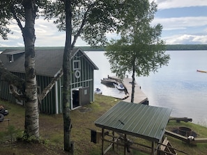 Looking down from house to fire pit, shore house, and dock