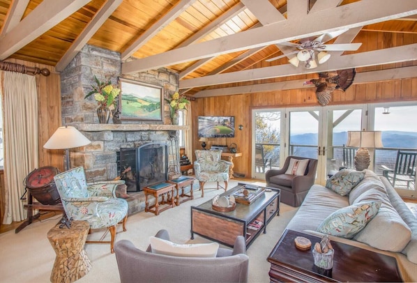 Main Living Area of Out On A Limb with Mountain Views, Stone Wood-Burning Fireplace, and HD Smart TV