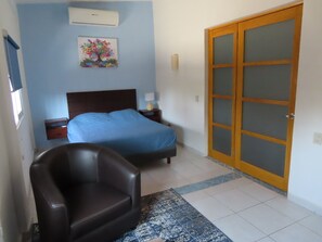 Room 1 with Queen bed, AC and private lounge with TV