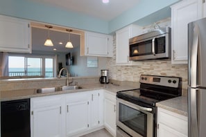 As you make a little snack in the newly renovated kitchen you can enjoy the view of the Sand Castle oceanfront condo