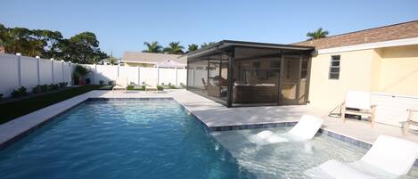 Salt water pool and large covered lanai in fully fenced backyard.