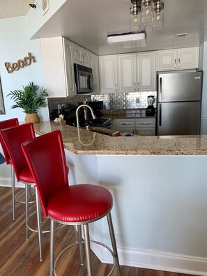 Wrap around bar with 3 bar stools