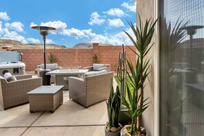 Beautiful, fully enclosed backyard with an 8-person patio table, gas fire pit table, extra seating, BBQ and a hot tub