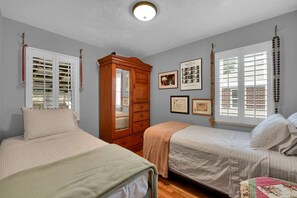 Country Charm is evident in the room with two Twin Beds and Antique Armoire.