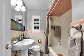Built in 1948, this bathroom reflects something of the era with the pink tile accents, maintained and kept clean for each guest turnaround.