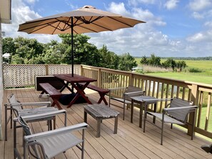 Deck overlooking the marsh.  Large picnic table and sitting area on deck with double umbrella.  Always beautiful views.