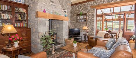 The living room is full of character with oak beams and oak floors.