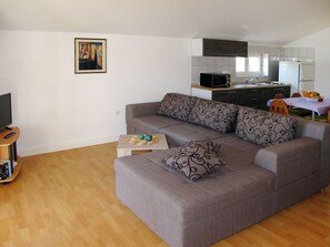 Furniture, Living Room, Room, Property, Floor, Interior Design, Couch, Wall, Building, Laminate Flooring