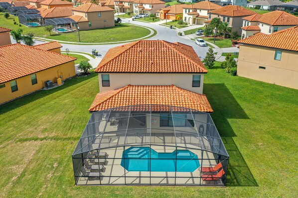 Spacious backyard with a private pool and screened patio for ultimate relaxation.