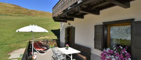 Building, Property, Furniture, Sky, Plant, Table, Shade, Chair, Flower, Flowerpot