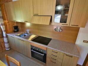 Cabinetry, Countertop, Property, Furniture, Wood, Kitchen, Interior Design, Kitchen Stove, Flooring, Floor