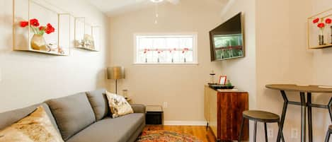 Comfy living room with big screen tv and dinette table with two chairs