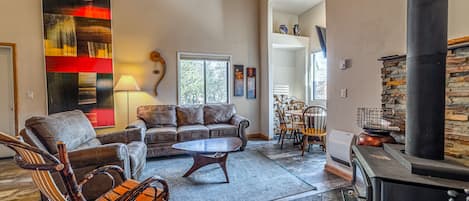 Open living area with vaulted ceilings and upgraded luxury vinyl flooring.