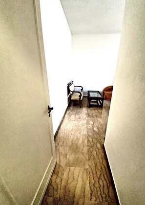 Entrance to the bedroom, marble floors and vintage sofa and coffee table