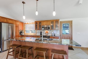 Beautiful open kitchen with breakfast bar seating for four.