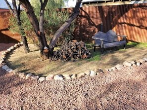 sitting area back by parking area with extra wood for small fire pits