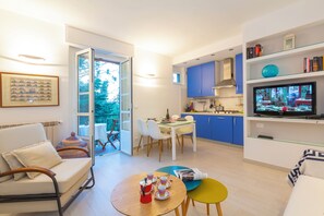 View of the living room with tv and kitchen