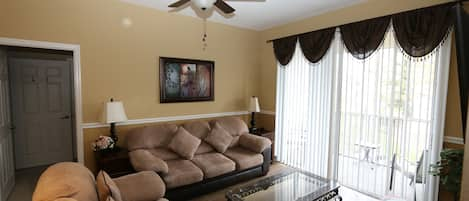 Lounge area with comfy sofas, patio door to balcony