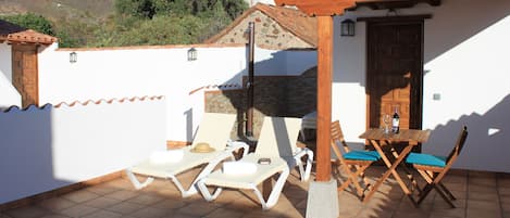 Terrace with sun loungers and solar shower