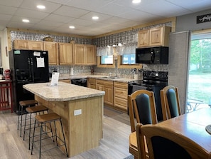 Kitchen area with snack bar and dishwasher