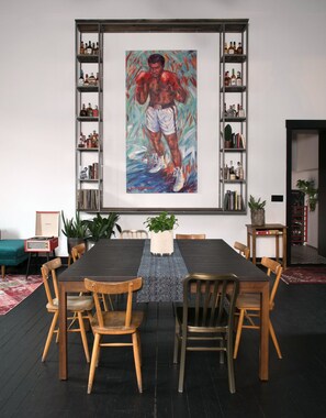 Dining table seats 8. View of bourbon alter and large-scale Ali painting