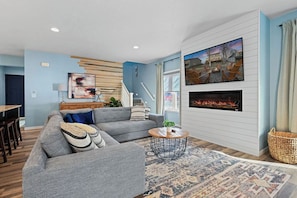 Cozy up by the fireplace and enjoy movie nights on the 65-inch smart TV