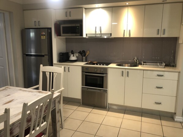 Kitchen with cutlery, dishes, cookware, coffee machine