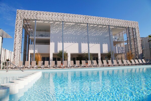 Lounge around the on-site outdoor pool.