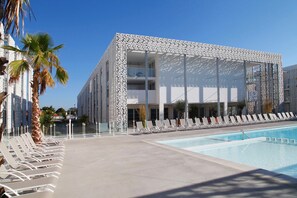 Lounge by the pool in the sunshine.