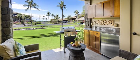 Partial ocean view from the lanai of this Hali'i Kai condo, with seating and private grill/wet bar.