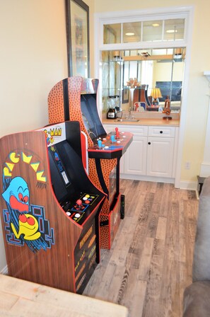 Video arcade games and wet bar in living area.